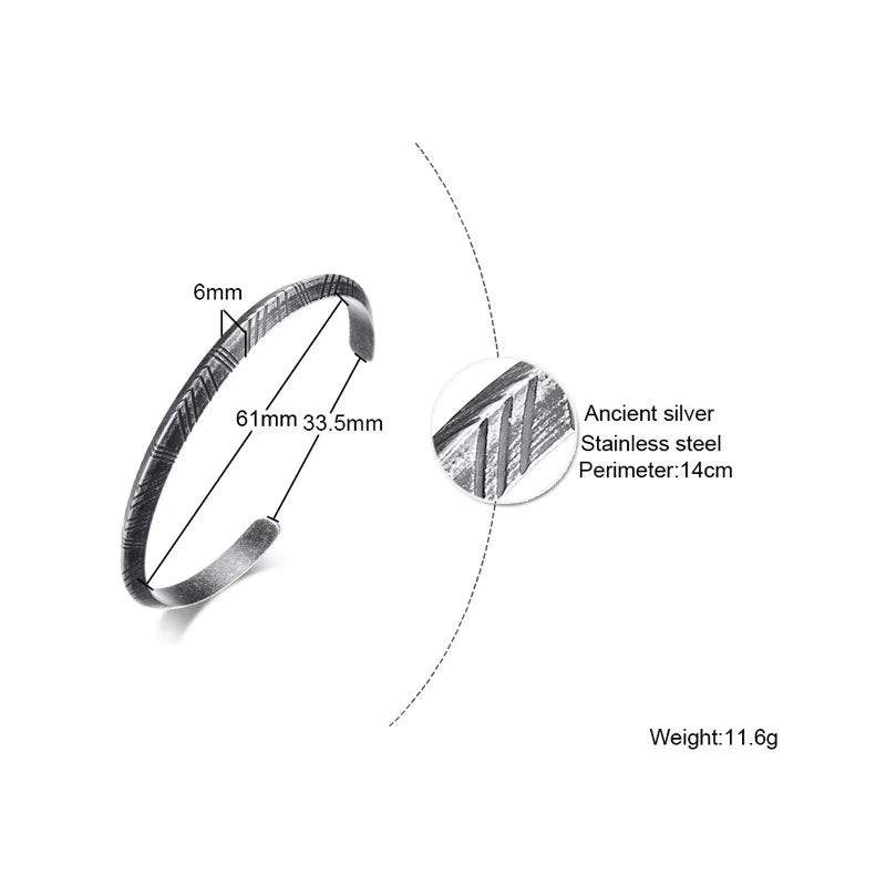 Aureliss Ryder Manschettenarmband aus grauem Edelstahl mit 6 mm Breite und detaillierter Oberflächenstruktur